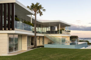 Jura Beige Ripple stone cladding on a house with an infinity pool.